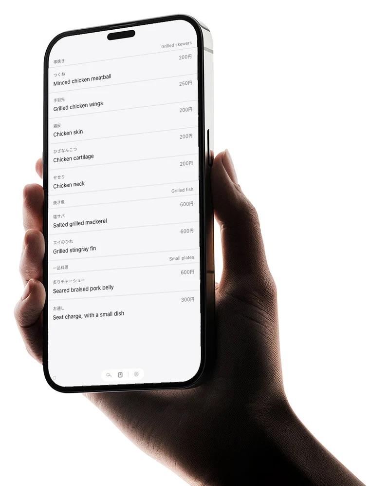 A Japanese izakaya menu read in English, on a phone held in hand
